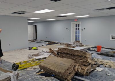 Construction images of the new children's area with partial ceiling & tarps on the carpet