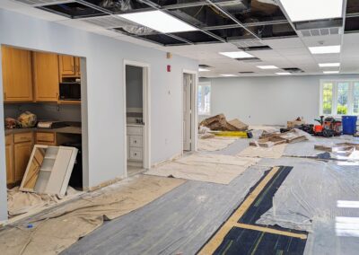 Construction images of the new children's area with partial ceiling & tarps on the carpet