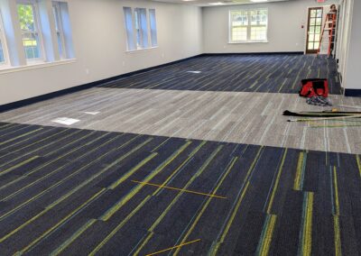 construction tools scattered in a room on a new carpet with new floor boards