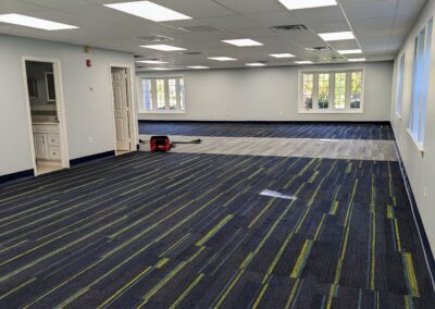 construction tools scattered in a room on a new carpet with new floor boards