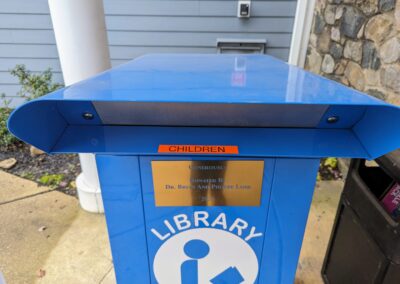 Children's return bin to the left in front of the library building