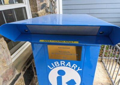 Adult/Young adult return bin to the right in front of the library